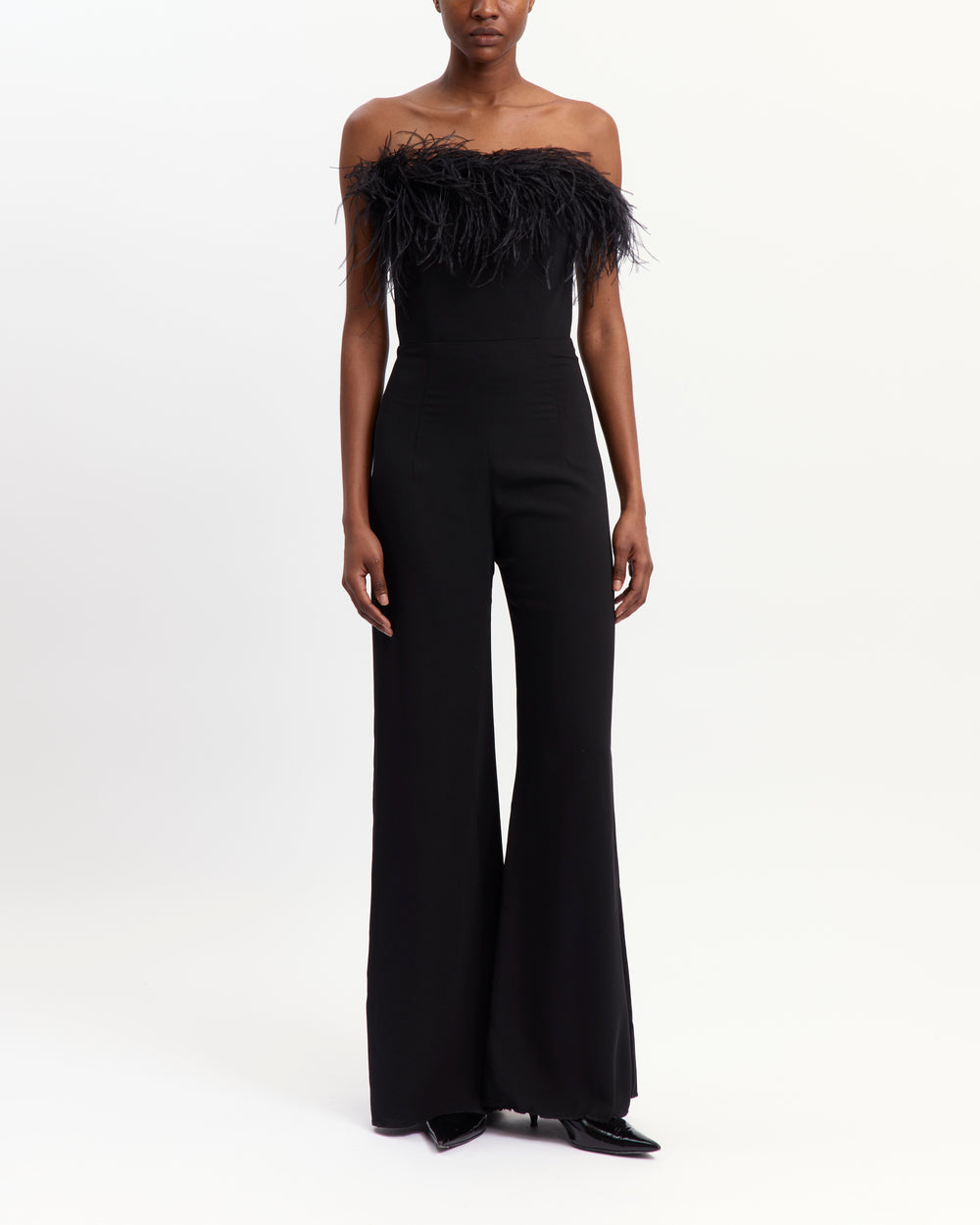 16Arlington Taree black strapless crepe jumpsuit with ostrich feather–trimmed bust, internal corset and floor-grazing flared legs, ideal for formal evening occasions from a luxury British designer brand.