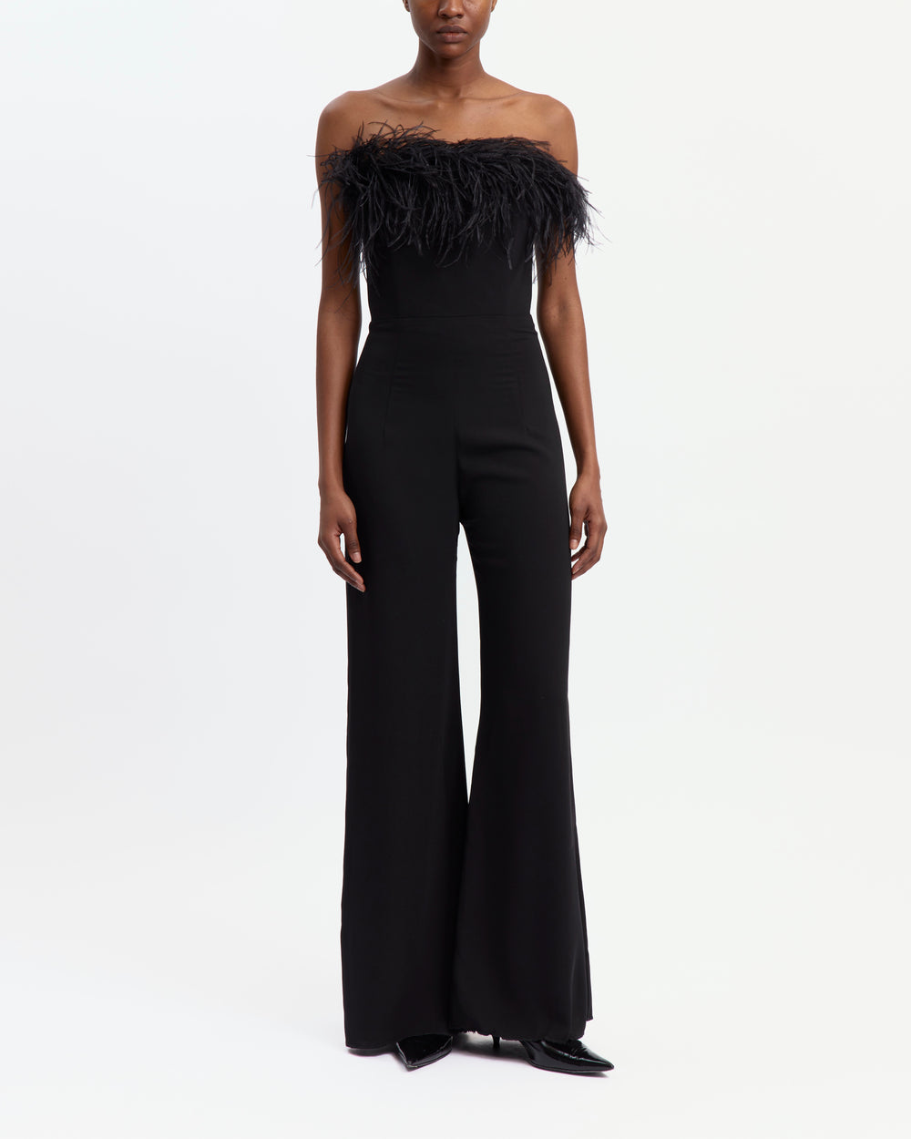 16Arlington Taree black strapless crepe jumpsuit with ostrich feather–trimmed bust, internal corset and floor-grazing flared legs, ideal for formal evening occasions from a luxury British designer brand.
