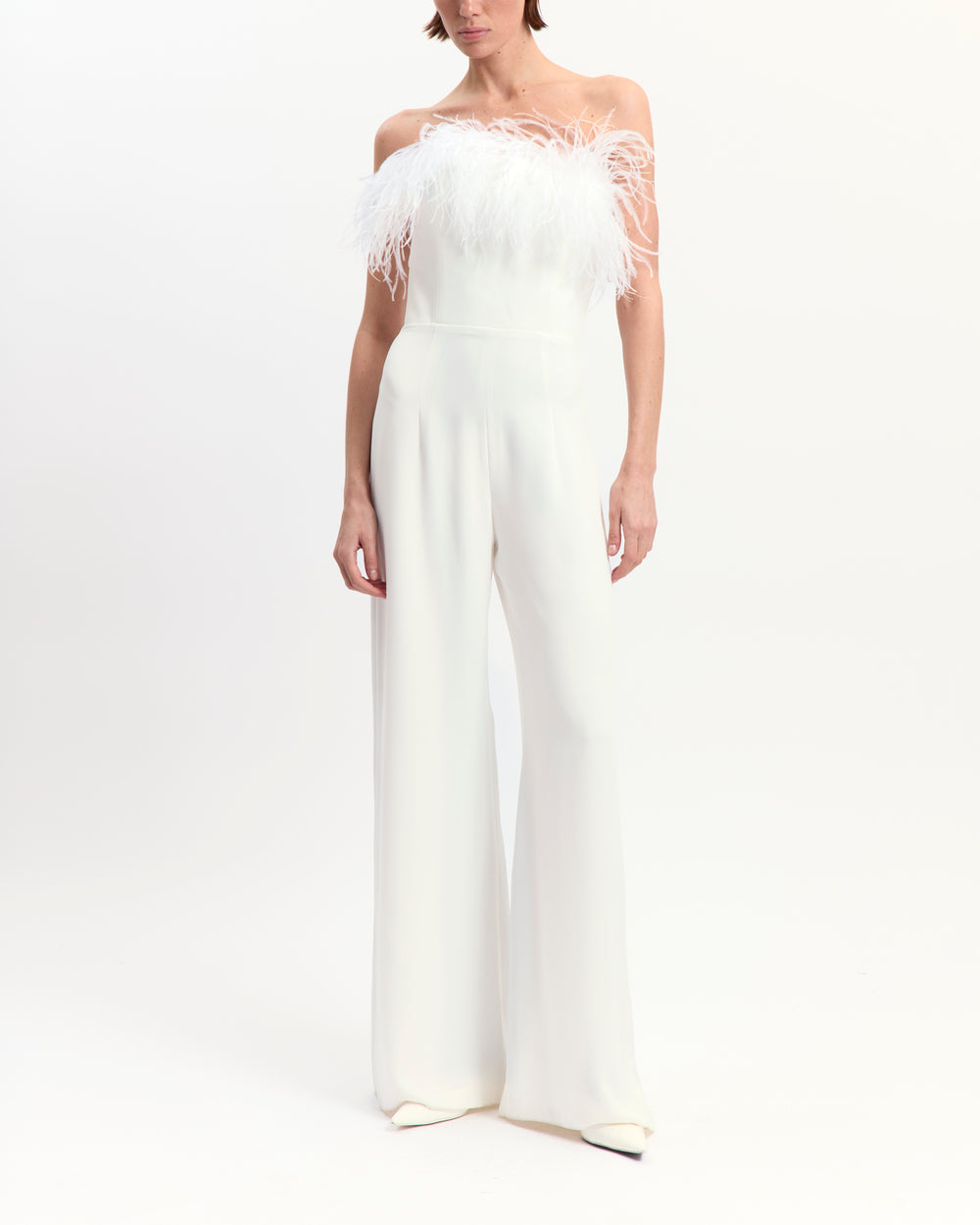 16Arlington Taree white strapless crepe jumpsuit with ostrich feather–trimmed bust, internal corset and floor-grazing flared legs, ideal for formal evening occasions from a luxury British designer brand.