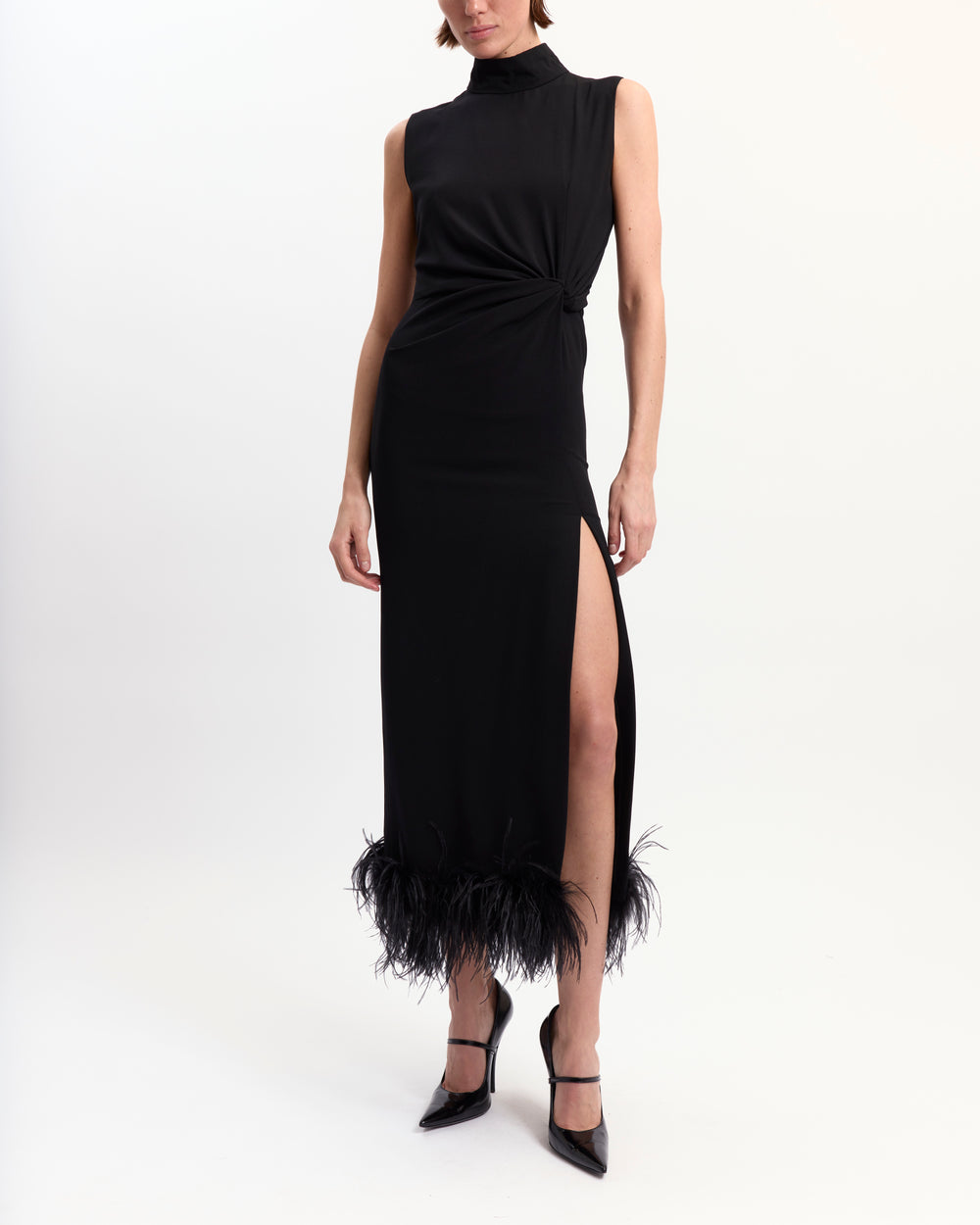 16Arlington Maika black crepe sleeveless midi dress with high neck, front twist detailing, side slit and feather-trimmed hem, ideal for cocktail and evening occasions from a luxury British designer brand.