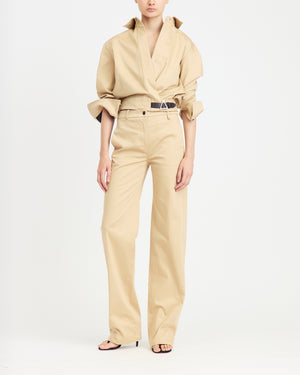 16Arlington Jolie jacket in sand-coloured cotton sateen, featuring a cropped silhouette with a cinched waist, plunging neckline and pointed collar with ruched sleeves and contrast leather buckle. This jacket brings signature tailoring to elevated daytime and evening looks from a luxury British designer brand. - front view