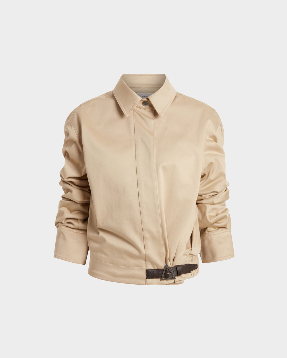 16Arlington Jolie jacket in sand-coloured cotton sateen, featuring a cropped silhouette with a cinched waist, plunging neckline and pointed collar with ruched sleeves and contrast leather buckle. This jacket brings signature tailoring to elevated daytime and evening looks from a luxury British designer brand.