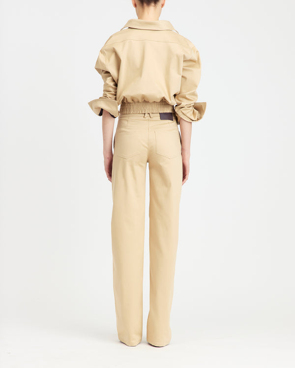 16Arlington Junia trouser in refined sabbia cotton sateen, featuring a mid-waist fit and a clean straight-leg silhouette. Designed for modern tailoring, this versatile piece reflects contemporary styling from a luxury British designer brand, ideal for elevated day-to-evening dressing. - back view