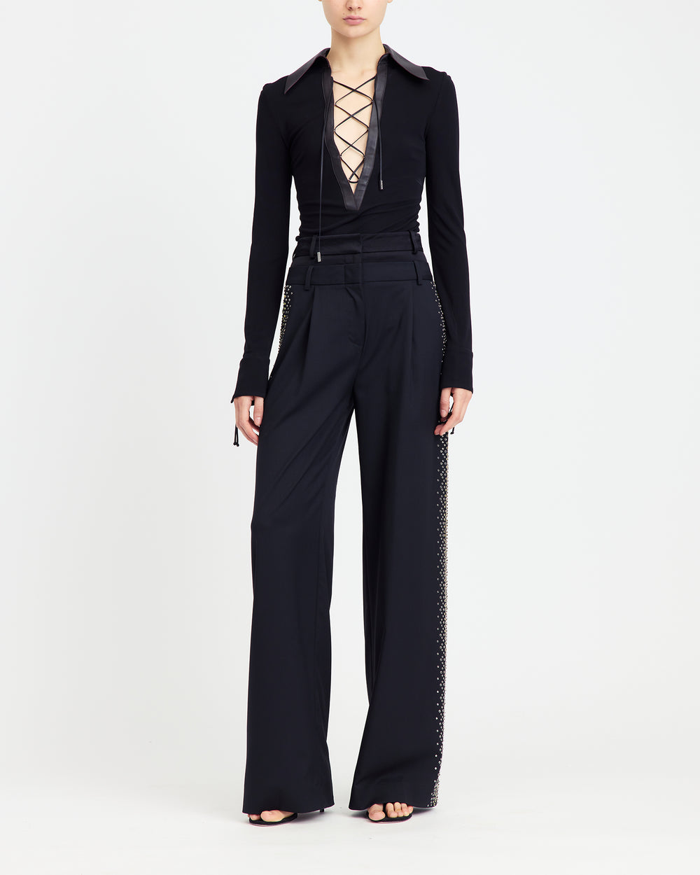 16Arlington Pia top with black smooth jersey, featuring a plunging V-neckline framed by a brown leather pointed collar with branded metal-tipped cord lacing. This refined piece brings modern tailoring to everyday and party looks from a luxury British designer brand.