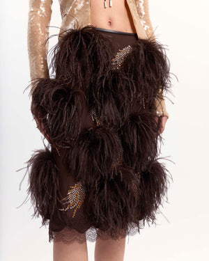 16Arlington Arno midi skirt in chocolate satin, designed in a pencil silhouette, featuring feather-pattern crystal hot-fix applications and plumes of feather trim, finished with hand-applied scalloped lace at the hem, ideal for occasion wear and statement dressing from a luxury British designer brand. - close-up