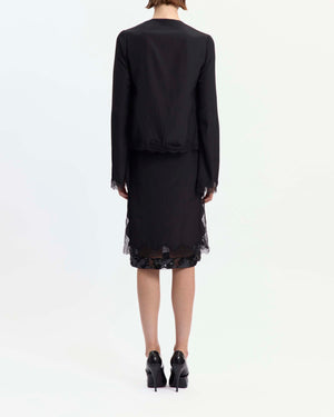 16Arlington Tirso skirt in black satin, designed in a straight silhouette falling just below the knee, featuring scalloped lace trim and a hand-embroidered sequin panel, finished with side split detailing and a tulle lining, ideal for evening styling and occasion wear from a luxury British designer brand. - back view