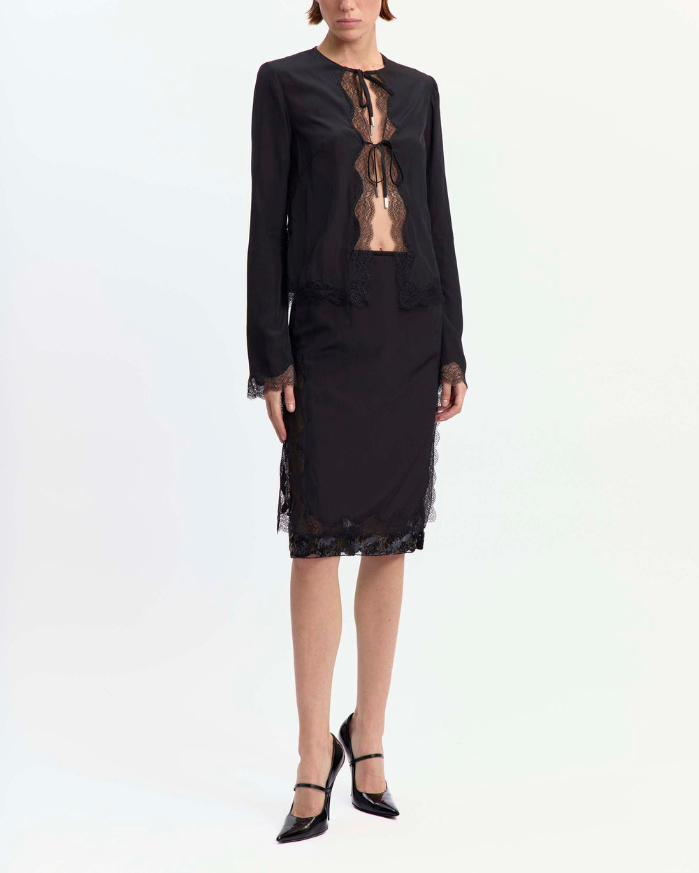 16Arlington Tirso skirt in black satin, designed in a straight silhouette falling just below the knee, featuring scalloped lace trim and a hand-embroidered sequin panel, finished with side split detailing and a tulle lining, ideal for evening styling and occasion wear from a luxury British designer brand.