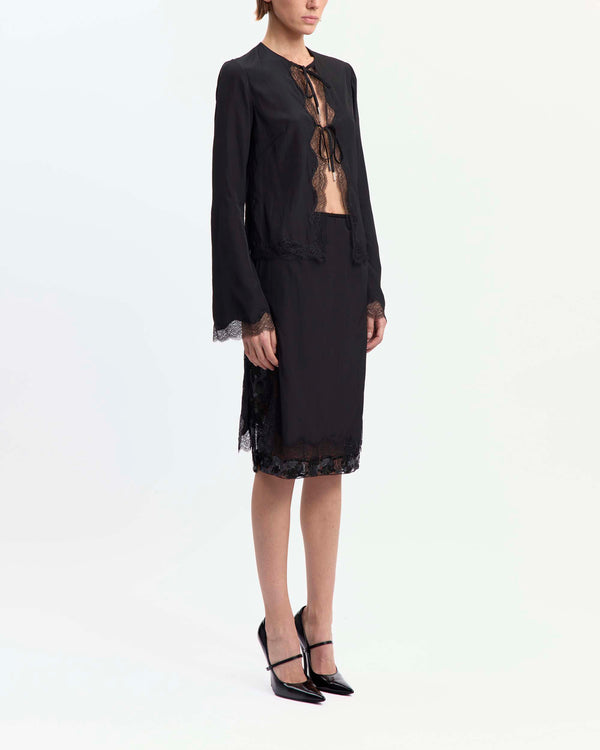 16Arlington Tirso skirt in black satin, designed in a straight silhouette falling just below the knee, featuring scalloped lace trim and a hand-embroidered sequin panel, finished with side split detailing and a tulle lining, ideal for evening styling and occasion wear from a luxury British designer brand. - side view